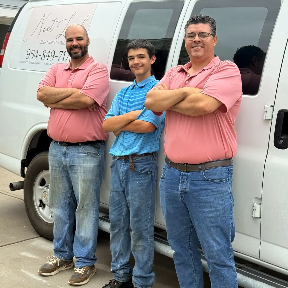 The Next Level Cleaning crew in front of the company van